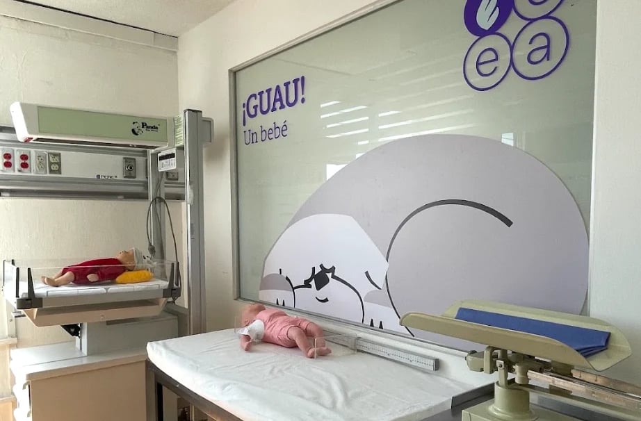 Pediatric medical examination room with sleeping character wall decal and medical equipment