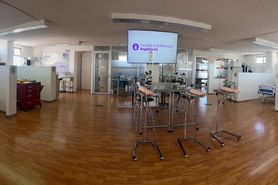 Modern office space with wooden floors, display screen, collaborative workstations, and white partition walls throughout